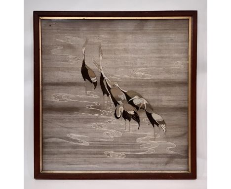 A vintage tapestry of seven cranes standing in water, possibly Japanese, colour thread with silver thread background, 71 x 74