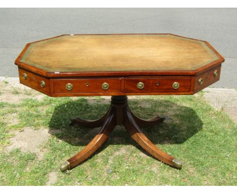 A Regency mahogany library writing table, the octagonal top inlaid in green and gilt tooled leather six real and four dummy f