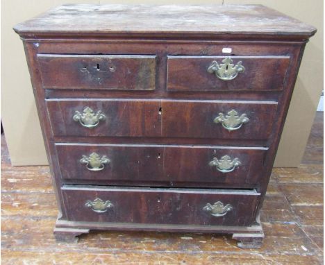 An 18th century countrymade walnut chest of three long and two short drawers, oak lined, with fluted and canted corners, rais