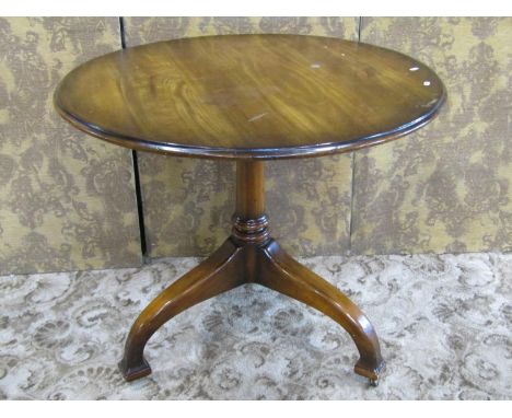 A walnut tripod table on turned pillar and tripod supports, 79cm high 91cm. 