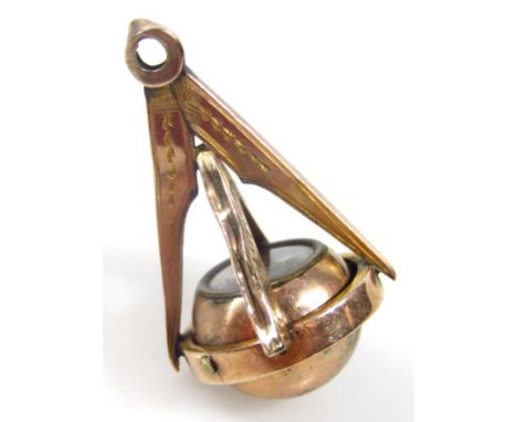 An early 20thC Masonic compass fob, with articulated orb centre, 4cm high. 