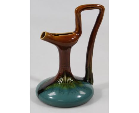 A Linthorpe pottery Dr Christopher Dresser design pottery ewer, with shaped spout, angular handle, inverted cylindrical stem 