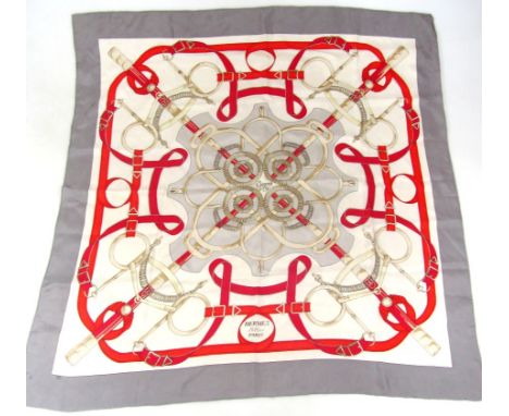 A Hermes silk scarf, in red, cream and grey, with repeat geometric pattern, marked, 86cm x 87cm.