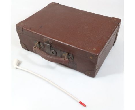 A mid 20thC pressed leather travel case, of rectangular outline with articulated handle and metal mounts, 12cm high, 36cm wid