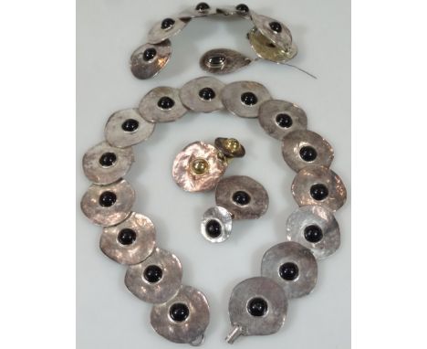 A Danish style necklace, set with disc pieces centred by black stones, unmarked, 45cm long, similar bangle and earrings. (a q