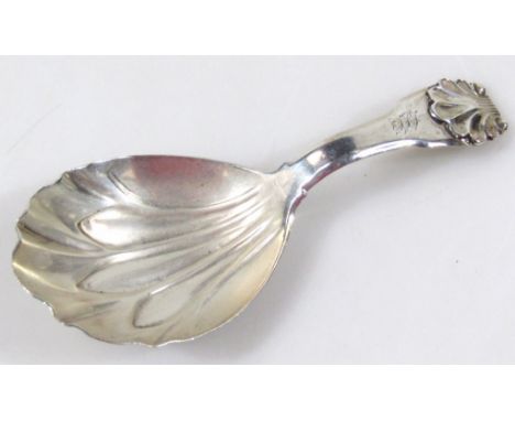 A George III silver caddy spoon, of shell capped Fiddleback pattern, with feathered bowl, London 1811, initialled, 10cm wide.