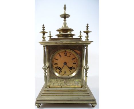A 19thC brass cased mantel clock, of classical Eastern design, surmounted by a circular finial above a 7cm dia. Roman numeric