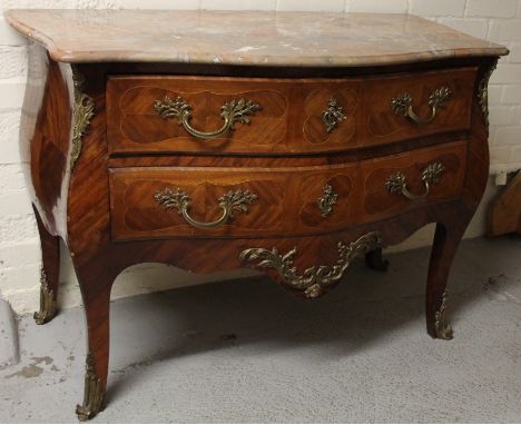 A Louis XIV style kingwood and marble finish bombe serpentine commode, the shaped top raised above two drawers with heavy gil