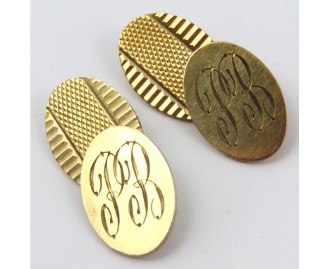 A pair of 9ct gold cufflinks, each with oval engine turned disc ends and chain centres, 2cm high, 10g, in fitted case. (monog