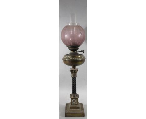 A Victorian brass red frosted and clear glass oil lamp, with cylindrical chimney, etched shade set with flowers and scrolls, 