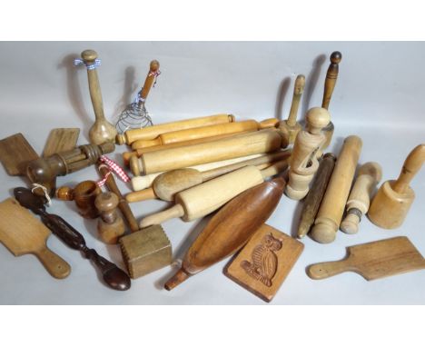 Various early 20thC and later treen, to include butter pats 25cm high, etc., rolling pin, other kitchen tools, owl mould, gar