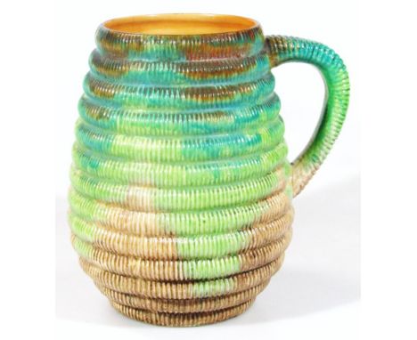 A 1950's Clarice Cliff jug, of cylindrical ribbed outline with splashes of green, turquoise and brown with shaped handle on c