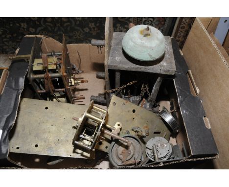 Box containing two long case clock movements and a Post Office alarm clock movement 