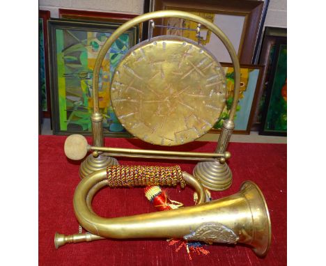 A brass bugle with applied Argyll and Sutherland crest, a brass gong with beater and a metal fire screen, (3). 