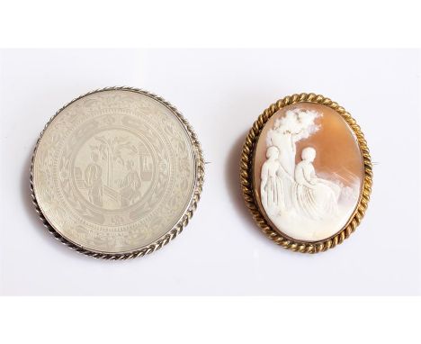 Carved shell cameo brooch, showing two ladies in a country scene and set in a gold plated frame, together with a Chinese moth