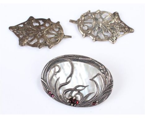 Art Nouveau style silver and mother of pearl brooch, with bull rush design, together with two white metal pendants, (3)