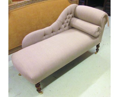CHAISE LONGUE, of small proportions with a buttoned back, a bolster cushion and grey upholstery on short turned supports with