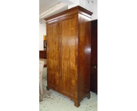 WARDROBE, 19th century mahogany with a pair of panelled doors enclosing a shelf and hanging rail on bracket supports, 56cm D 