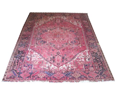 VINTAGE HERIZ CARPET, 320cm x 256cm, star medallion on a terracotta field of stylised palmettes and vines within correspondin