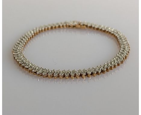 A diamond tennis or line bracelet with diamond decoration, 17.5 cm, hallmarked, 9.5g