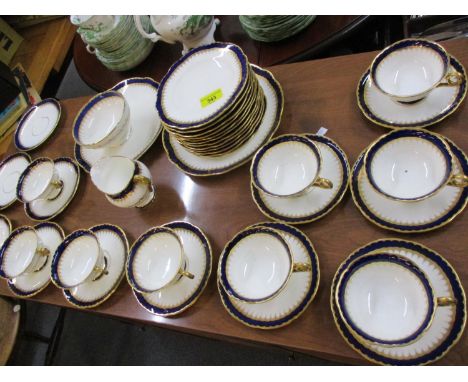 A Coalport part tea service having a white ground with cobalt blue and gilt band 
