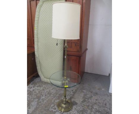 A mid 20th century brass standard lamp having a circular glass single tier, 55 1/2"h including shade 