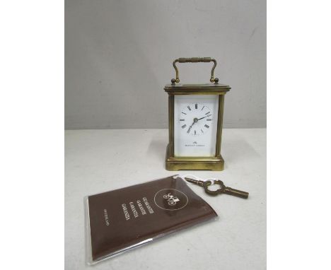 A Matthew Norman brass cased, five window carriage clock with guarantee booklet and keyLocation: 