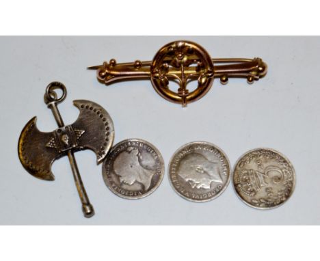 A 9ct gold brooch;  a silver axe pendant;   three silver threepence