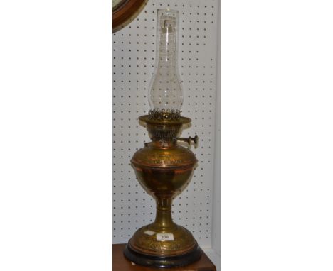 A Victorian brass oil lamp, embossed with scrolls, c.1890