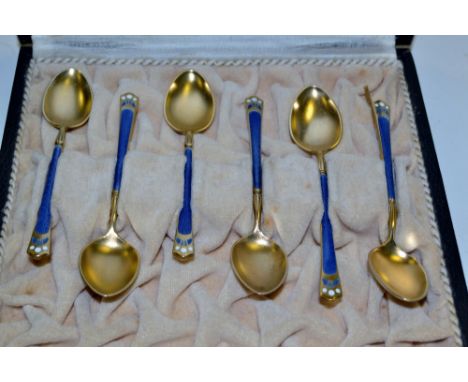 A set of six Art Nouveau silver gilt and enamel coffee spoons, by David Andersen, cased en suite, retailed by Theodore Olsens