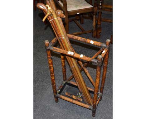A late 19th Century bamboo walking stick stand; a walking stick with handle in the form of a dog; etc