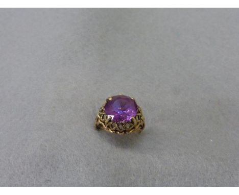 A 9ct gold amethyst ring, the stone set within a fretwork mount, size H/I. 