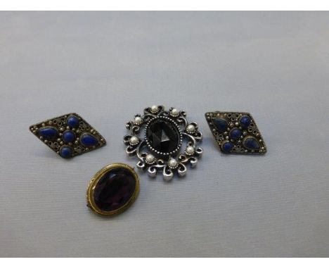 An Art Deco pendant, an amethyst brooch and a pair of earrings.