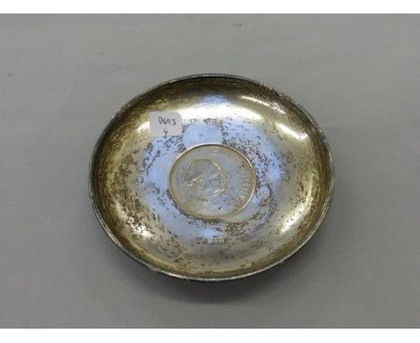 A silver pin dish with a 1965 Churchill crown to the well, maker R&D, London 1964.