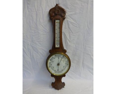 A carved oak aneroid banjo barometer. 