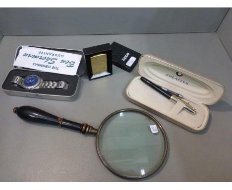 A cased Ben Sherman gentleman's wristwatch, a cased Zippo lighter and a large magnifying glass. 