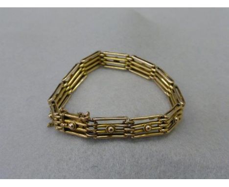A 9ct gold gate bracelet with safety chain. 