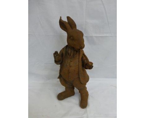 A cast iron Beatrix Potter figure - rabbit stood holding a pipe. 