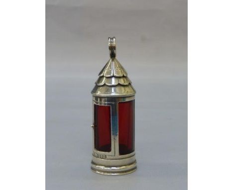 A Victorian silver and cranberry glass scent bottle in the form of a storm lantern, maker Samson Mordan, London 1882.