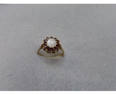 A 9ct gold opal and garnet flower shaped ring, size L. 