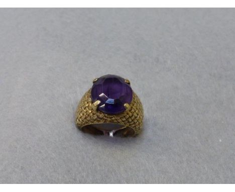 A gold (untested) basket weave ring set with a large amethyst, size I. 