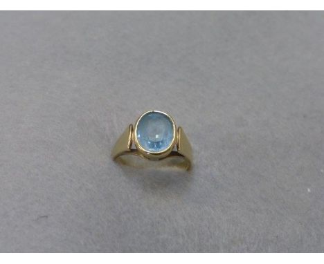 A 9ct gold ring set with a light blue stone. 