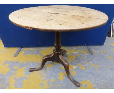 A 19th Century oak circular tea table raised upon tripod supports. 