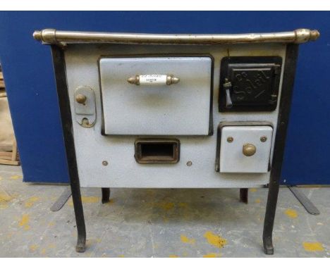 Yesterday's World Museum Ironmongers - an early enamel stove marked to one porcelain handle Le Soleil; also a set of scales a
