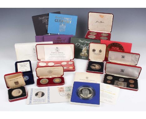 A collection of various commemorative coins and medallions, including a set of four John Pinches London silver medallions cel