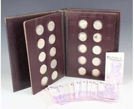 A John Pinches London set of sixty silver medallions celebrating the Genius of Michelangelo 1475-1564, within a gilt-decorate