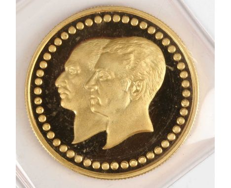 A small Iran gold medallion commemorating the 50th Anniversary of Bank Melli and the Pahlavi Dynasty 1941-1979, obverse with 