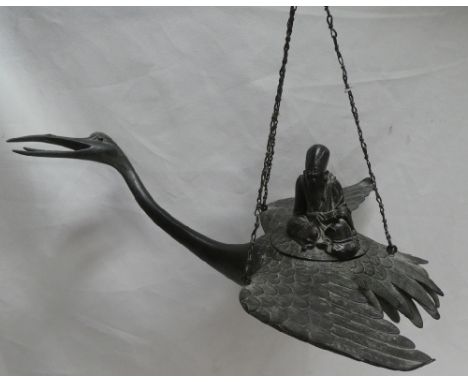 A 19th century Japanese bronze hanging incense burner in the form of a flying crane, the lid decorated with a seated immortal