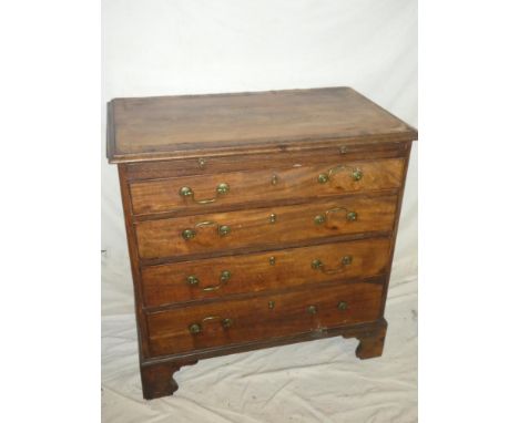 A small George III mahogany cross-banded chest of four long graduated drawers below a brushing slide, brass ring handles on b