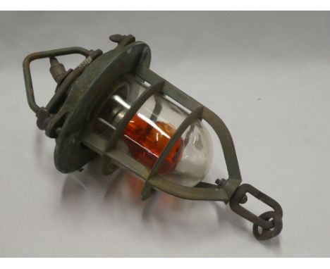 A bronze nautical hanging light with domed glass cover